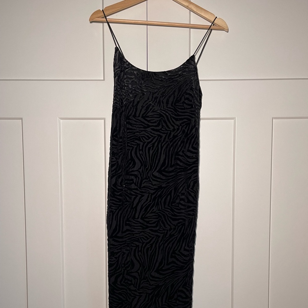 Black midi length spaghetti strap dress with a velvet zebra pattern.